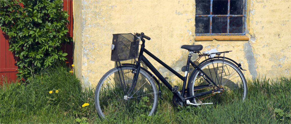 A bicycle leaning against a wall